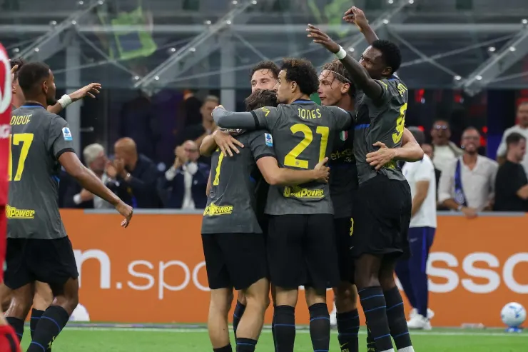 Giocatori dell'Inter esultano insieme in campo dopo un gol, abbracciati con le braccia alzate